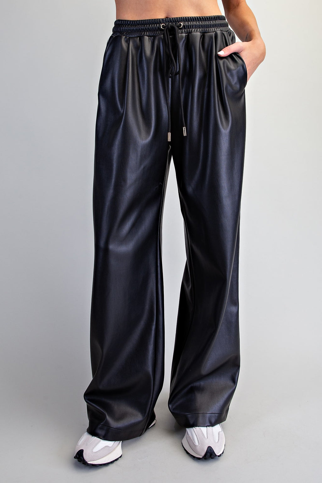 Front view of black faux leather wide-leg pants showing the elastic drawstring waistband.