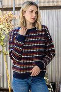 Model wearing a Staccato navy honeycomb knit sweater with burgundy, mustard, and cream stripes.