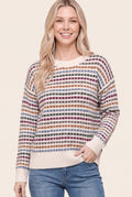 Front view of a model wearing a Staccato cream textured sweater with magenta, camel, and blue-gray stripes.